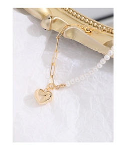 Detail of S925 silver bracelet with pearls, gold paperclip links and heart charm