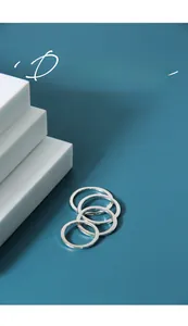 Polished 925 sterling silver minimalist rings displayed on a blue background