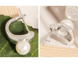 Detailed macro view of S925 sterling silver earring with pearl and engraved S925 stamp