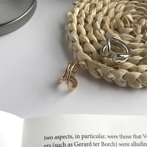 Macro view of 925 sterling silver hollow curved rings in gold and silver finish