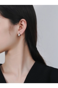Detail of S925 silver earring featuring a minimalist streamline design and white pearl