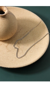 Macro detail of 925 sterling silver curb chain choker necklace with adjustable extender