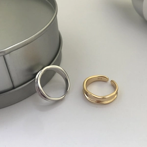 Macro view of S925 sterling silver stamp on minimalist gold and silver open rings