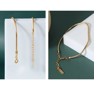 Detail of gold snake chain bracelet featuring lobster clasp, extension and S925 stamp