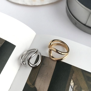 Detail of minimalist 925 sterling silver hollow double ring set in gold and silver finish