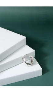 Detail of S925 sterling silver multilayer knotted open ring on minimalist white display