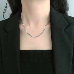 Detail of 925 sterling silver curb chain choker necklace on model with black suit