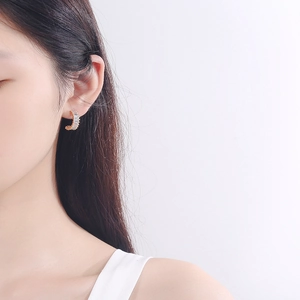 Elegant gold C-shaped hoop earrings with rectangular cubic zirconia on female model