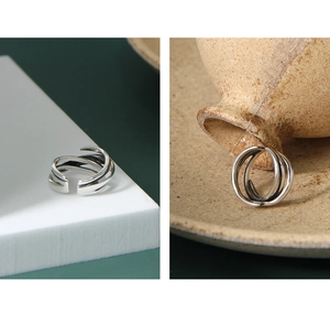 Macro shot of minimalist multilayer winding S925 sterling silver ring with oxidized finish