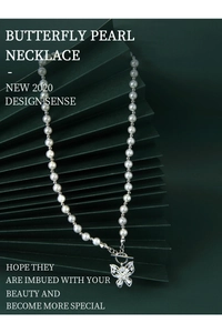 Detail of S925 silver butterfly necklace with white pearls and sparkling cubic zirconia