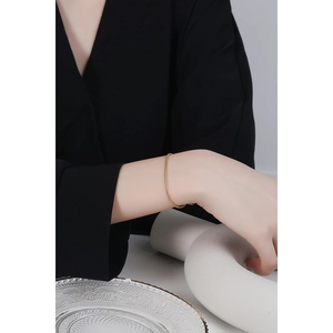 Minimalist S925 sterling silver gold snake bone chain bracelet worn on a female wrist
