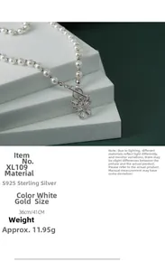 Macro detail of S925 sterling silver butterfly pendant with zircon and lustrous pearls