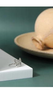 Macro detail of silver butterfly ring featuring intricate hollowed wings and polished finish