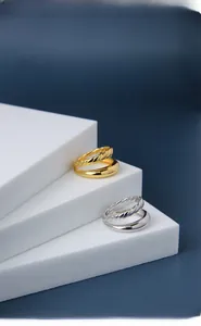 Macro view of gold and silver double-layered rings with twisted rope texture detail