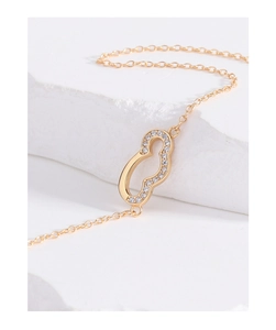 Detailed close-up of a gold wulu pendant necklace encrusted with shimmering cubic zirconia