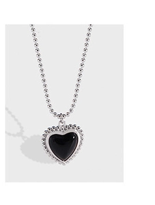 Detail of heart necklace featuring black agate pendant and silver beaded chain link