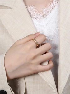 Detail of a gold bamboo-style S925 sterling silver ring worn on the index finger
