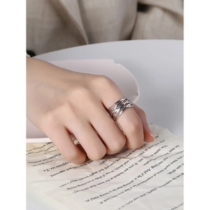 Multi-layer crossed lines S925 sterling silver ring worn on index finger in minimalist style