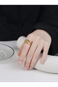 Macro detail of gold layered twisted rope ring and polished band on model finger