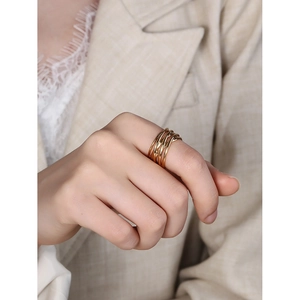 Elegant gold minimalist multi-layer intertwined geometric ring for women in hand view