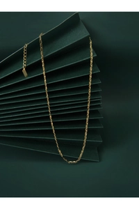Detailed macro of gold plated pig nose necklace showing interlocking oval chain links