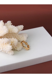 Detailed shot of golden organic wave S925 sterling silver ring on a white display