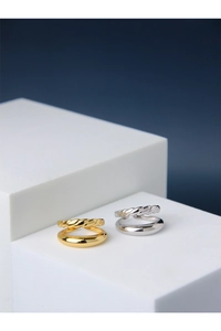 Detail view of double-layered silver and gold rings with rope texture on a white stand