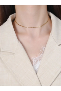 Close-up of minimalist gold S925 sterling silver chain necklace worn by a female model