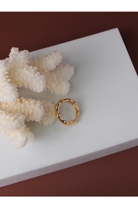Detail of golden bamboo texture sterling silver open ring with artistic molten finish