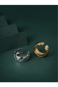 Detailed view of silver and gold S925 sterling silver rings with quilted pattern texture