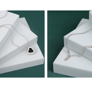 Detailed macro view of S925 sterling silver black onyx heart necklace and adjustable chain clasp