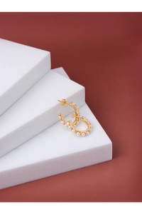 Close-up of golden C-shaped wreath earrings with white pearls on a red-brown backdrop