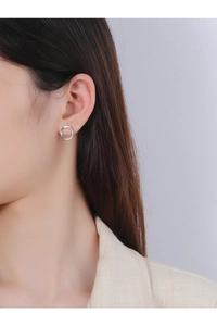 Close-up of minimalist S925 sterling silver irregular round stud earring on female ear