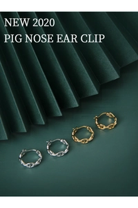 Detailed macro view of S925 sterling silver pig nose ear clips in gold and silver finish