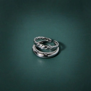 Double-layered twist textured and polished silver rings set for women on green background