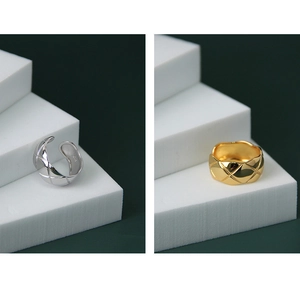 Detailed macro view of silver and gold rings featuring classic quilted diamond patterns