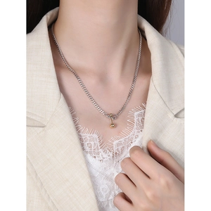 Elegant S925 silver necklace with golden ball pendant and T-bar clasp on female model