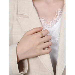 Minimalist 925 sterling silver gold beaded ring with zircon stone worn by a woman