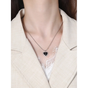 Elegant heart pendant necklace with black agate and silver beaded chain on model