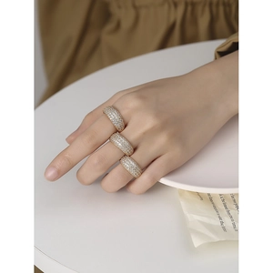 Three wide S925 silver rings with full zircon stones worn on hand in an elegant setting