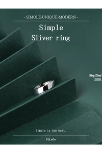 Macro shot of minimalist polished silver wide band ring on a green geometric background
