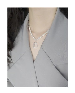 Close-up of S925 sterling silver hollow heart pendant on natural freshwater pearl necklace