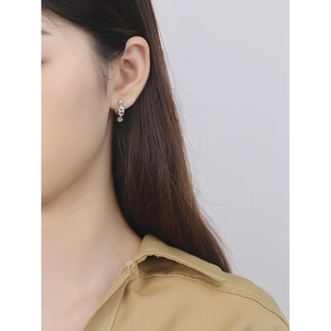 Minimalist S925 sterling silver pig nose hoop earrings worn by a model in a close-up view