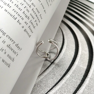Macro shot of minimalist S925 sterling silver ring with chic twisted knot design details
