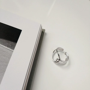Close-up of S925 sterling silver ring with minimalist double-line twisted knot design