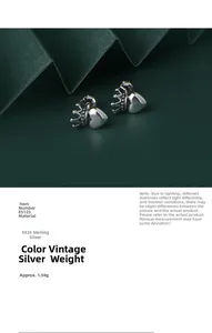 Close-up of S925 sterling silver heart and crown earrings with vintage finish