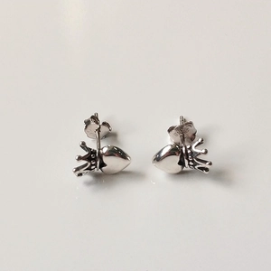 Detail of S925 sterling silver crown and heart stud earrings with hallmark engraving