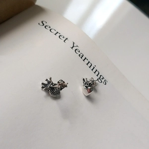 Macro detail of vintage S925 sterling silver crown heart stud earrings with oxidized finish