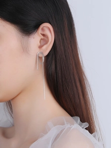 Detail showing the elegant S925 sterling silver box chain drop earrings on model