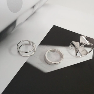 Macro shot of minimalist S925 sterling silver rings with hallmarked interior engraving